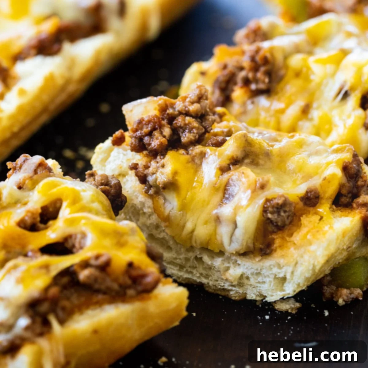 French Bread Sloppy Joe Pizza 2 Sloppy Joe French Bread Pizza cut into slices, showcasing the juicy filling and melted cheese.