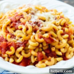 A vibrant bowl of Macaroni and Tomatoes, freshly prepared and ready to serve, highlighting its inviting texture.