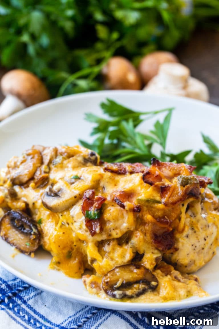Ultimate Bacon Mushroom and Cheese Stuffed Chicken 6 Two halves of Bacon, Mushroom, and Cheese Stuffed Chicken, showing the creamy filling inside.