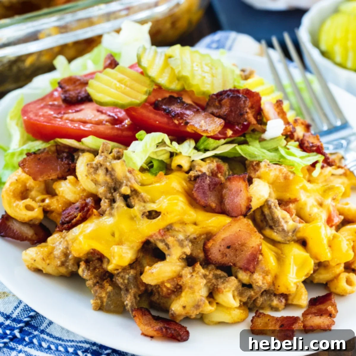 Bacon Cheeseburger Casserole with shredded lettuce and tomato on a plate.