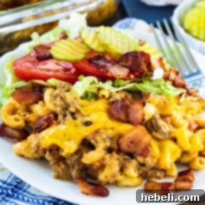 Bacon Cheeseburger Casserole with shredded lettuce and tomato on a plate.
