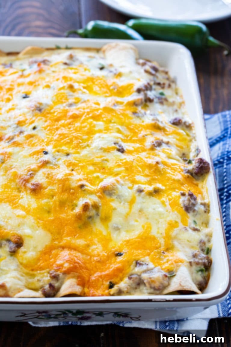 A baking dish filled with Southern Breakfast Enchiladas with Sausage Gravy, golden and bubbly.