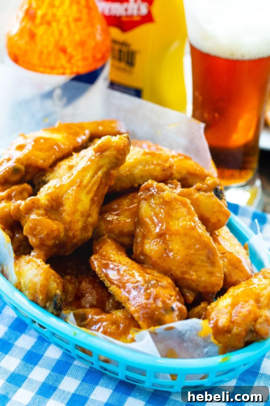 Zesty Carolina Mustard Wings 4 A basket full of golden-brown Carolina Mustard Wings, garnished and ready to serve.