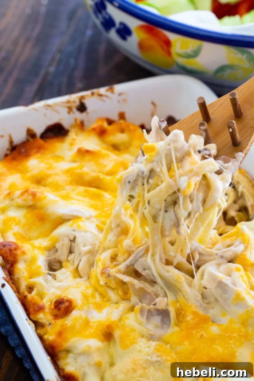 The Ultimate Chicken Alfredo 3 Million Dollar Chicken Alfredo with 4 cheeses! A close-up showing the melted cheese and pasta.