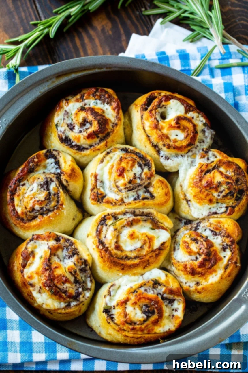 Golden Olive & Cheese Pinwheels 3 Easy Olive Cheese Rolls, showing the beautiful spiral cross-section of dough, cheese, and olive tapenade.