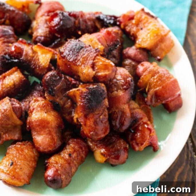 Candied Bacon Smokie Poppers 2 Plate of perfectly cooked Bacon Wrapped Little Smokies, golden brown and glistening.