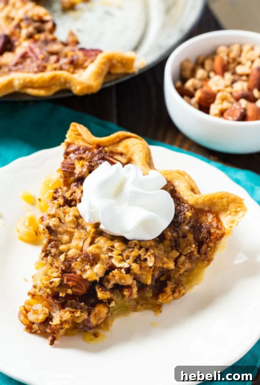 A close-up of a delightful slice of Toffee Nut Pie, generously topped with a cloud of homemade whipped cream, ready for a special occasion.