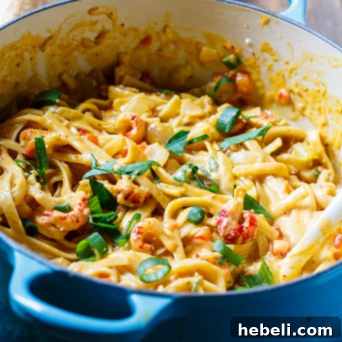 Creamy Crawfish Fettuccine, a rich and spicy pasta dish with generous amounts of crawfish tails