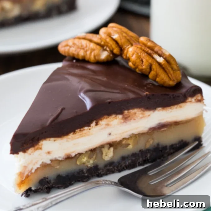Praline Cream Cheese Pie, a multi-layered dessert with an Oreo crust, praline, cream cheese, and chocolate ganache