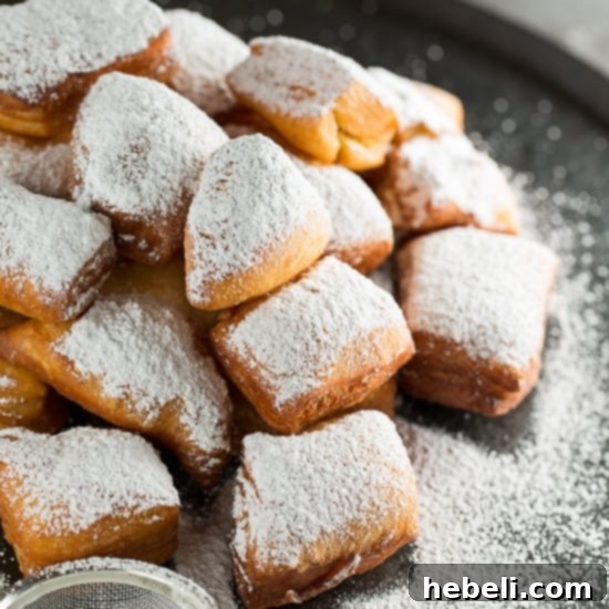 Homemade New Orleans Beignets, fluffy deep-fried dough coated in powdered sugar, a classic French Quarter treat