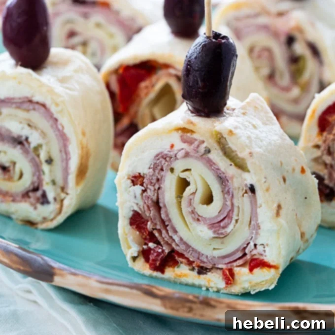 Muffaletta Pinwheels, savory rolled appetizers with olive salad and various deli meats, perfect for parties