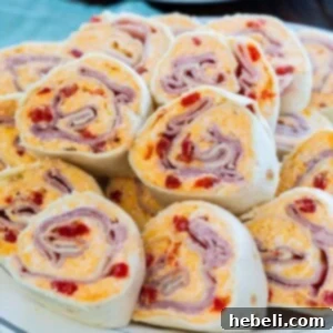Ham and Pimento Cheese Pinwheels, beautifully arranged on a platter, ready to serve.