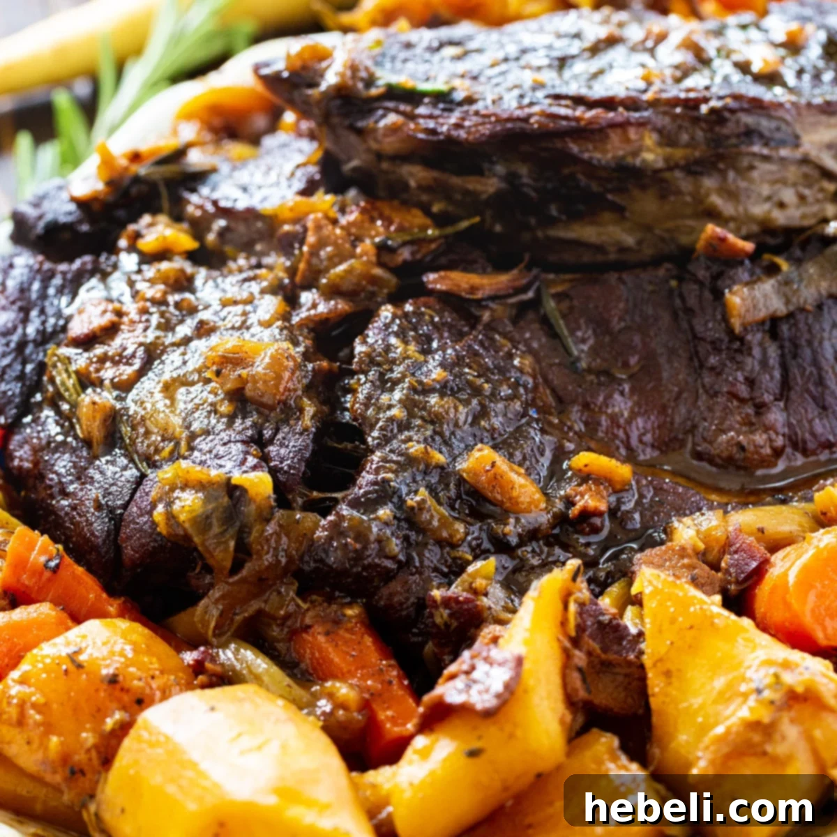 Close-up of a rustic Pot Roast surrounded by tender root vegetables in a flavorful gravy.