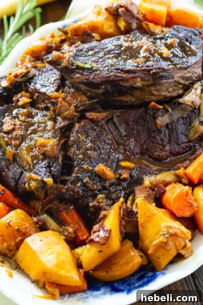 A generous serving of Pot Roast with an abundance of tender root vegetables, ready to be enjoyed.