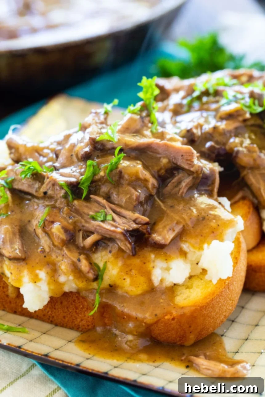 Close-up of Hot Beef Sandwiches with Mashed Potatoes and Gravy, showcasing succulent shredded pot roast.