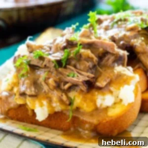A beautifully presented Pot Roast Open Faced Sandwich with gravy.