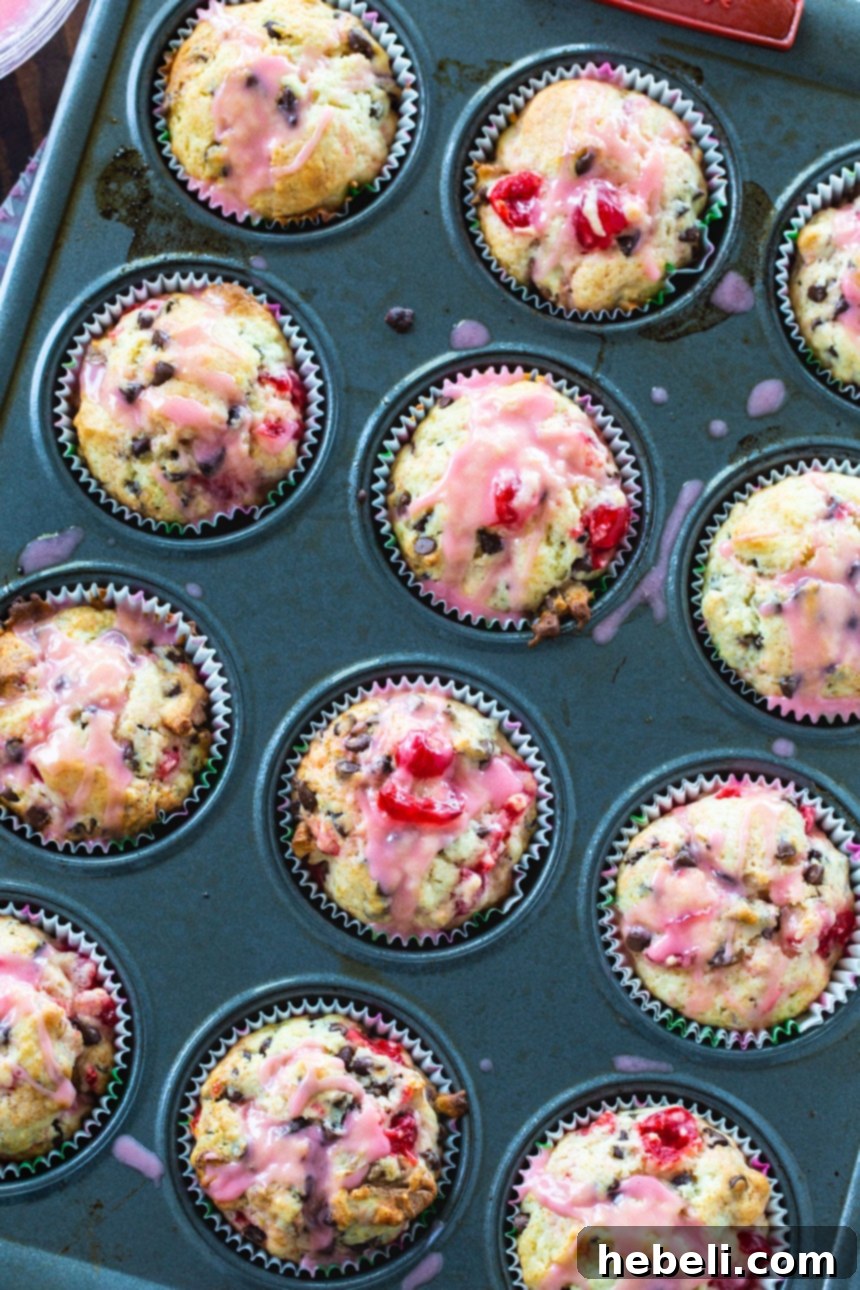 Close-up of baked Cherry Chocolate Chip Muffins with visible cherries and chocolate.