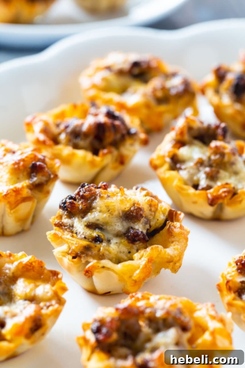 A close-up shot of baked Sausage Ranch Phyllo Cups, showing the golden-brown edges of the phyllo and the melted cheese.