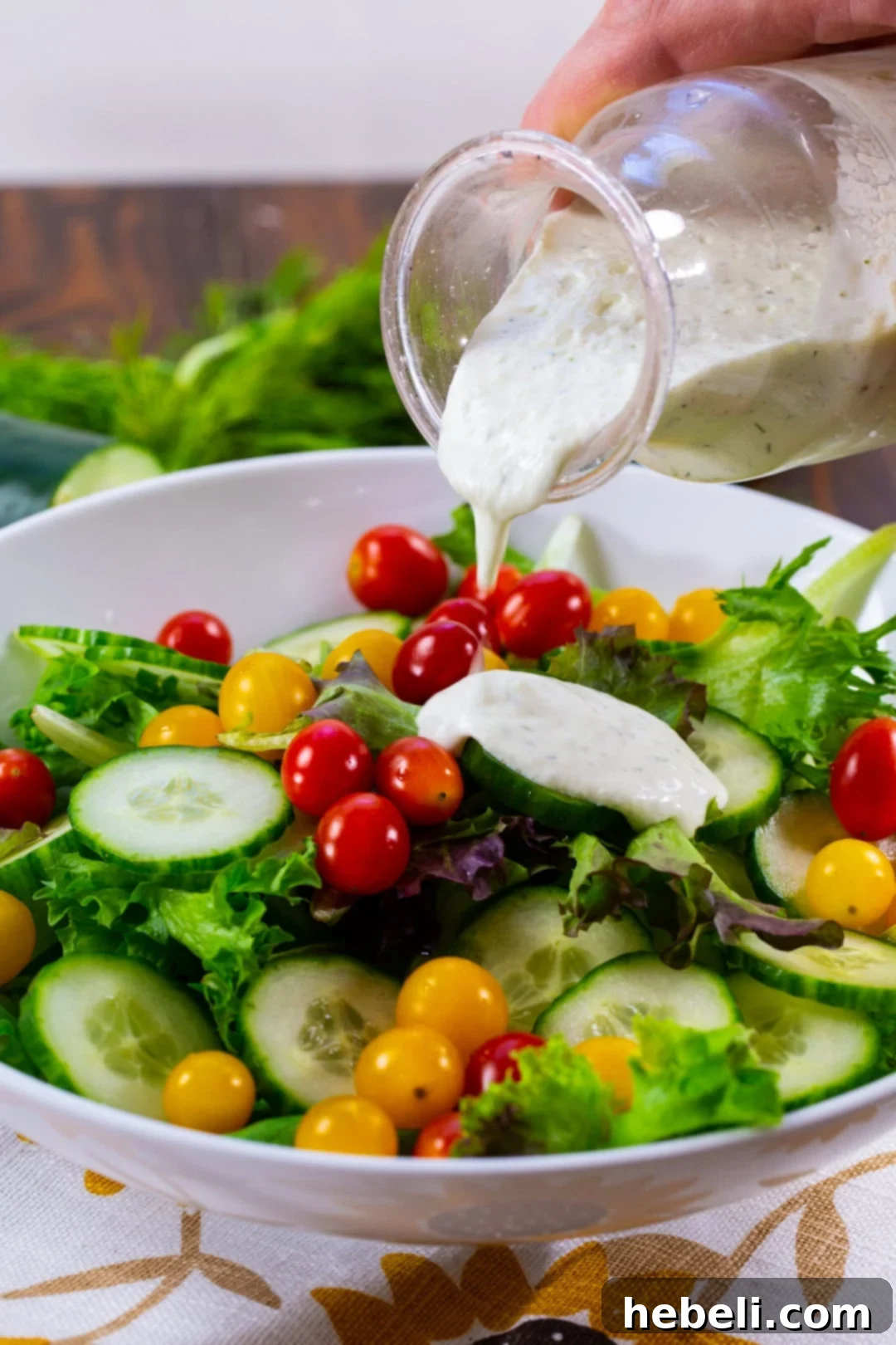 Close-up shot of Cucumber Dill Dressing beautifully drizzled over a fresh salad, showcasing its creamy texture and vibrant color.