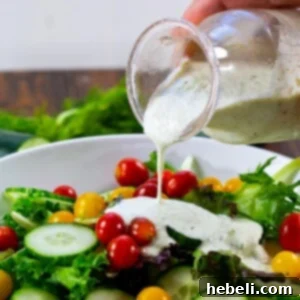 Finished Cucumber Dill Dressing in a bowl with fresh dill sprigs.