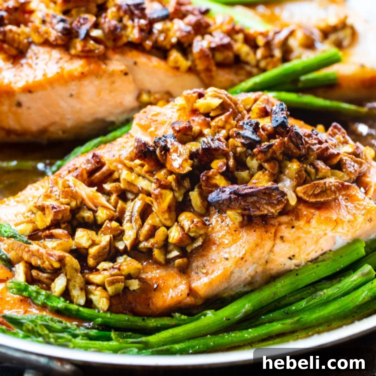 Bourbon-Pecan Glazed Salmon in a pan with asparagus, ready to be served.
