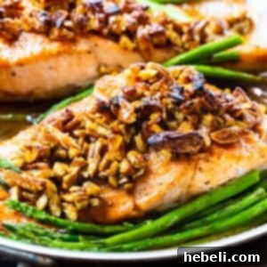 Bourbon-Pecan Glazed Salmon in a pan with asparagus