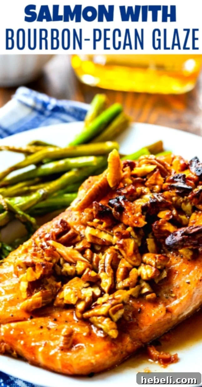 Close-up of Salmon with Bourbon-Pecan Glaze and asparagus on a white plate, highlighting the delicious texture and glaze.
