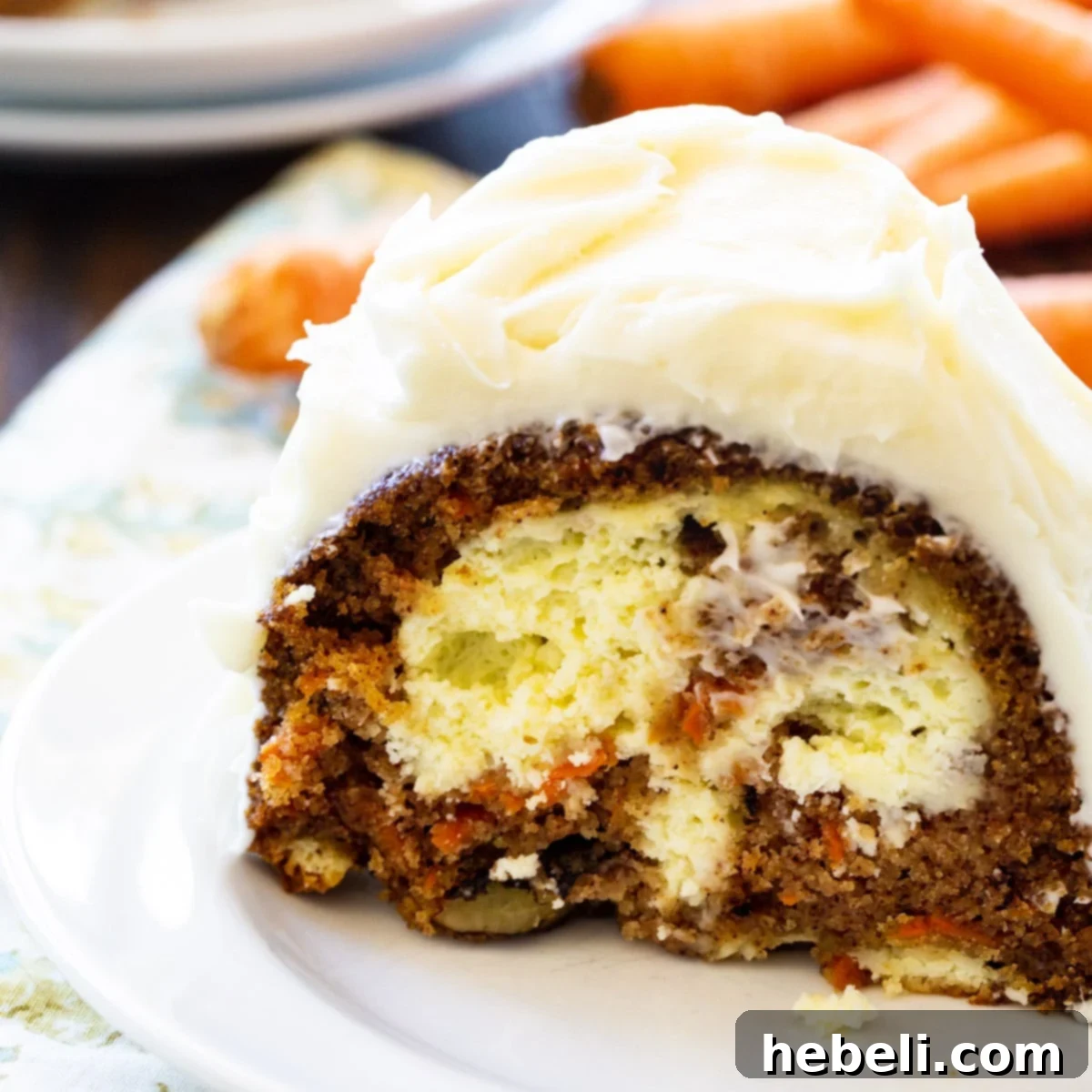 Slice of Cream Cheese Filled Carrot Cake on a plate, showcasing the creamy filling.