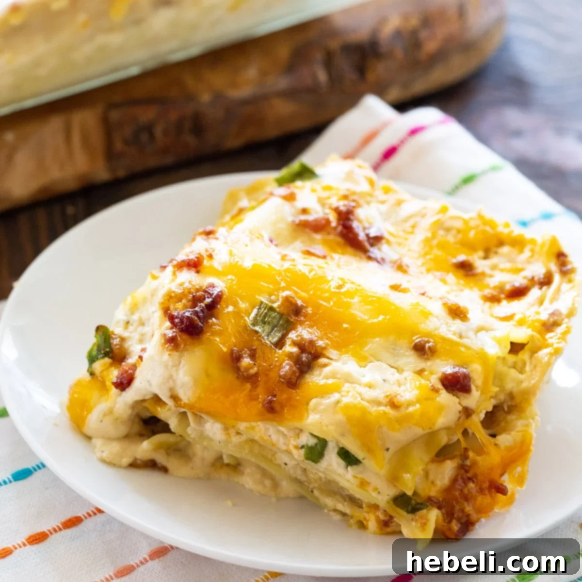 A delectable slice of creamy Chicken, Bacon & Ranch Lasagna on a plate, ready to be enjoyed.