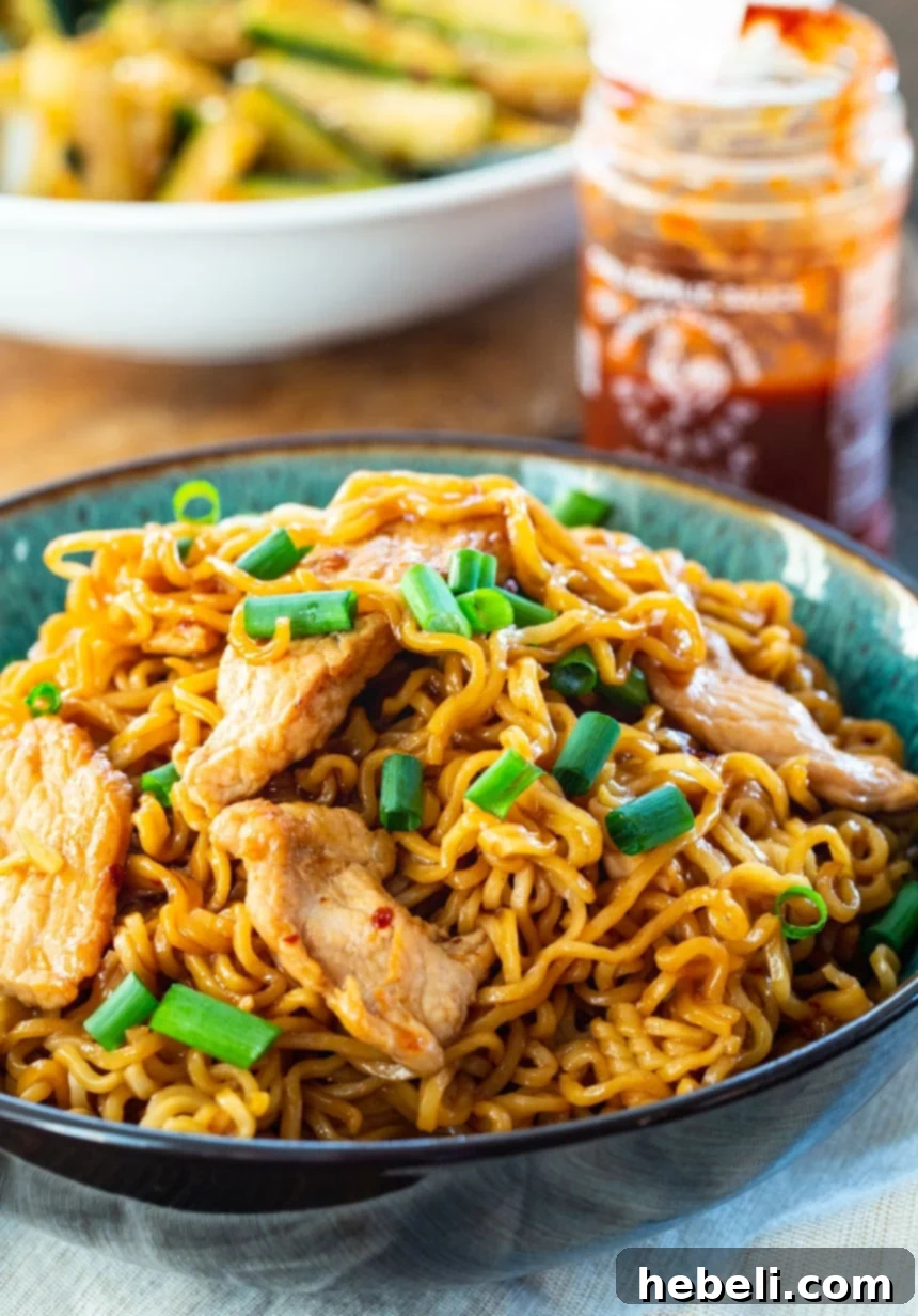 A close-up shot of a bowl of spicy pork ramen, highlighting the rich broth and toppings.