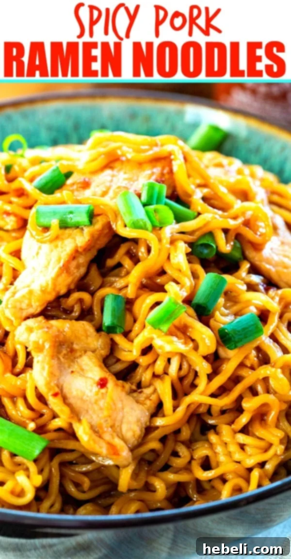 A beautifully presented bowl of Spicy Pork Ramen Noodles, garnished and ready to eat.