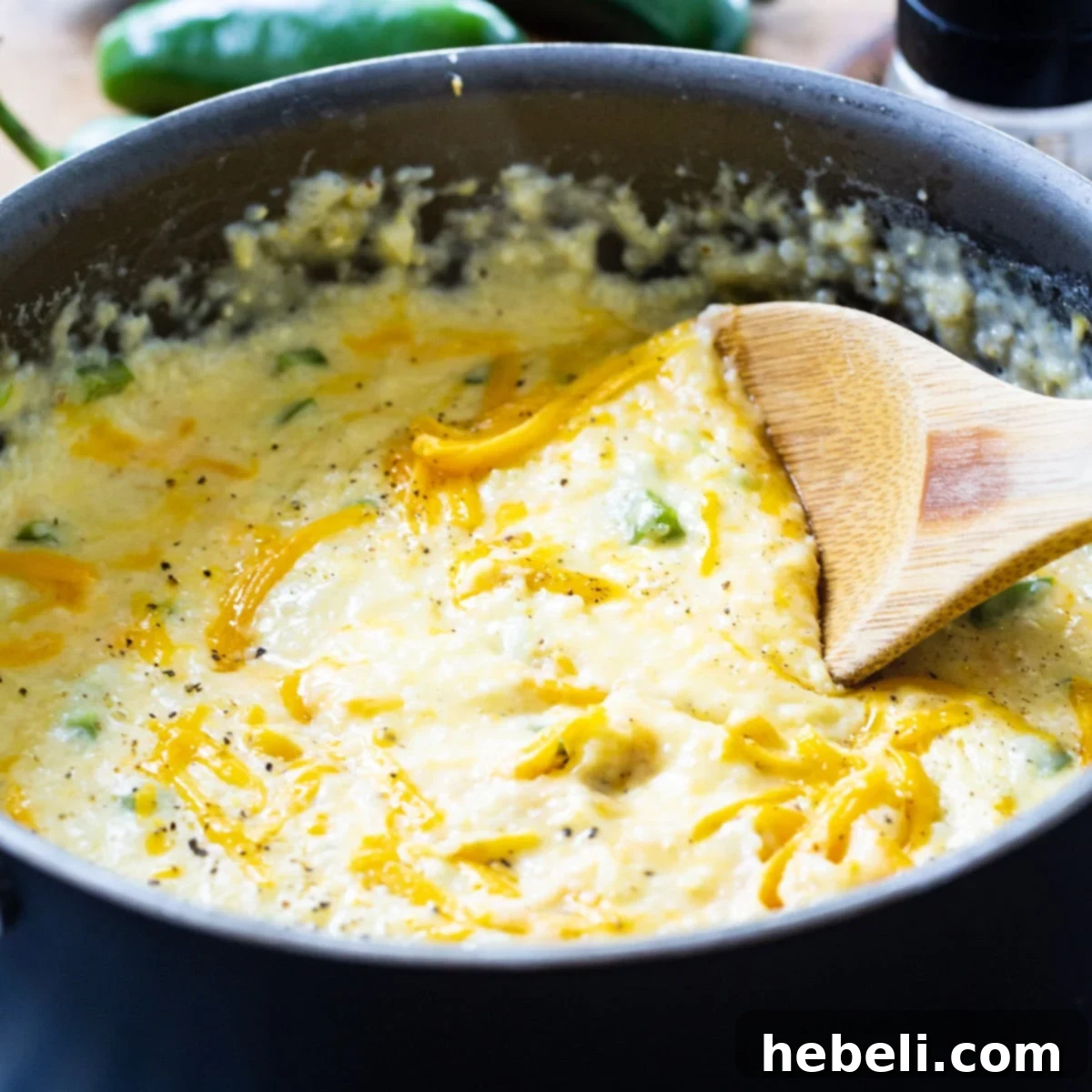 Jalapeno Cheddar Grits Delight 2 Large pot of creamy Jalapeno Cheddar Grits, ready to be served for a Southern meal.