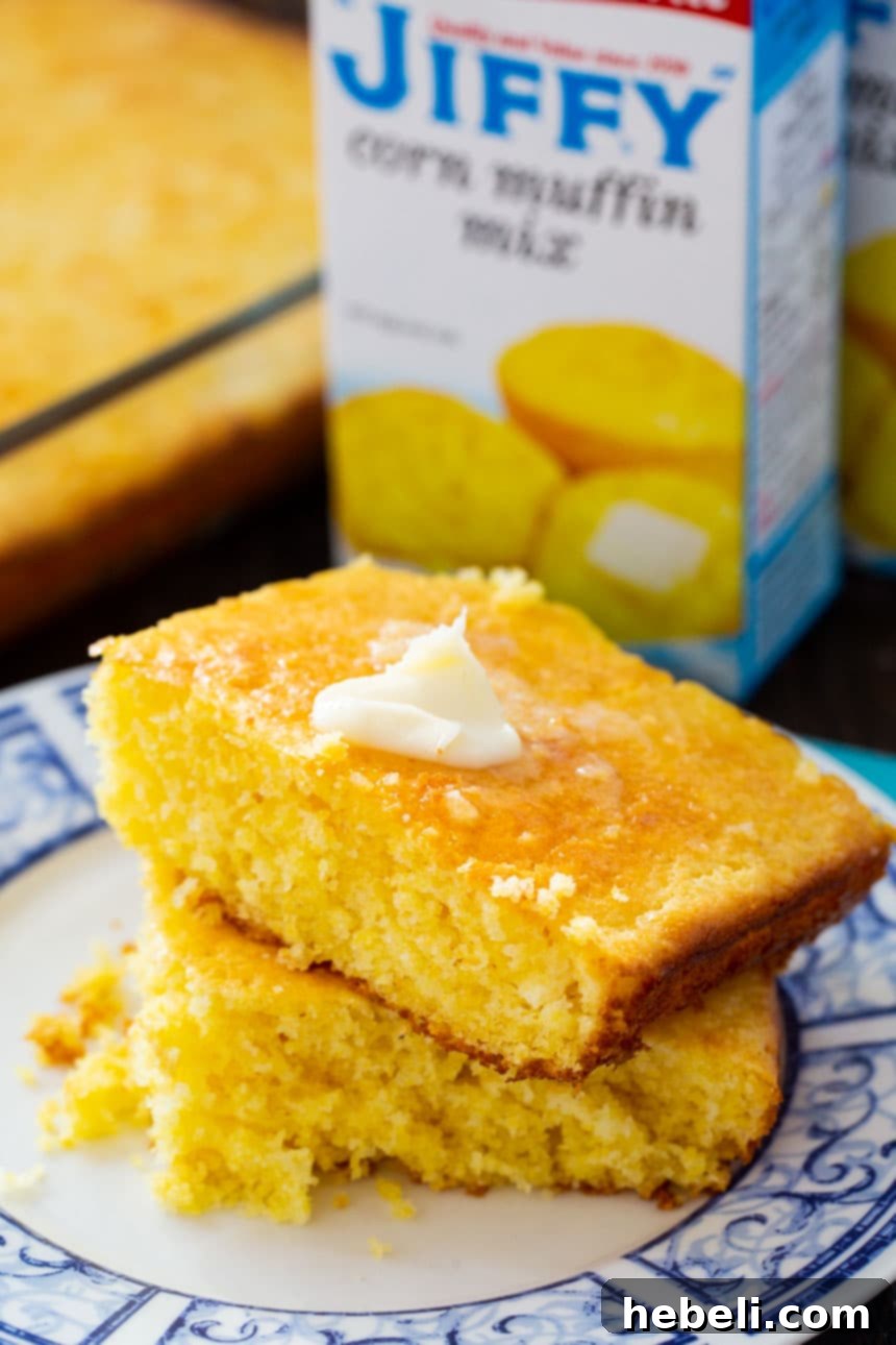 Your New Favorite Jiffy Cornbread 3 A generously sized pan of golden-brown Jiffy Cornbread, fresh from the oven, showing its moist and tender texture.