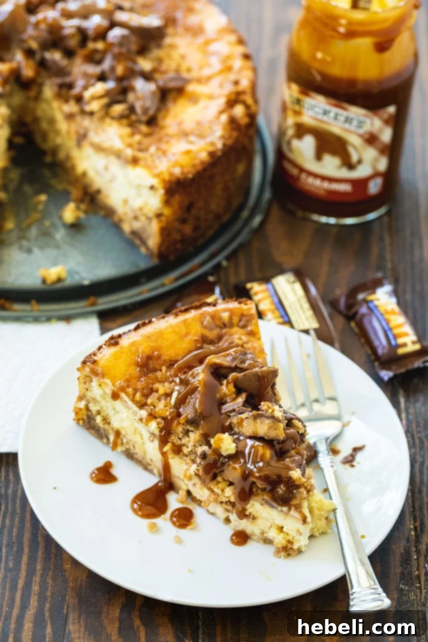 Luscious English Toffee Cheesecake 3 A mouth-watering slice of Toffee Cheesecake presented with a jar of caramel sauce in the background.