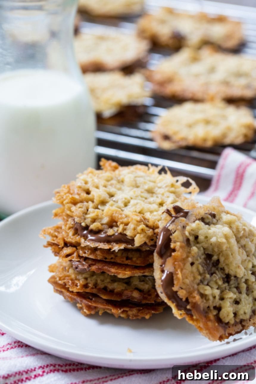 Chocolate Florentine Cookies arranged on a plate with a jug of milk, ready to be enjoyed.