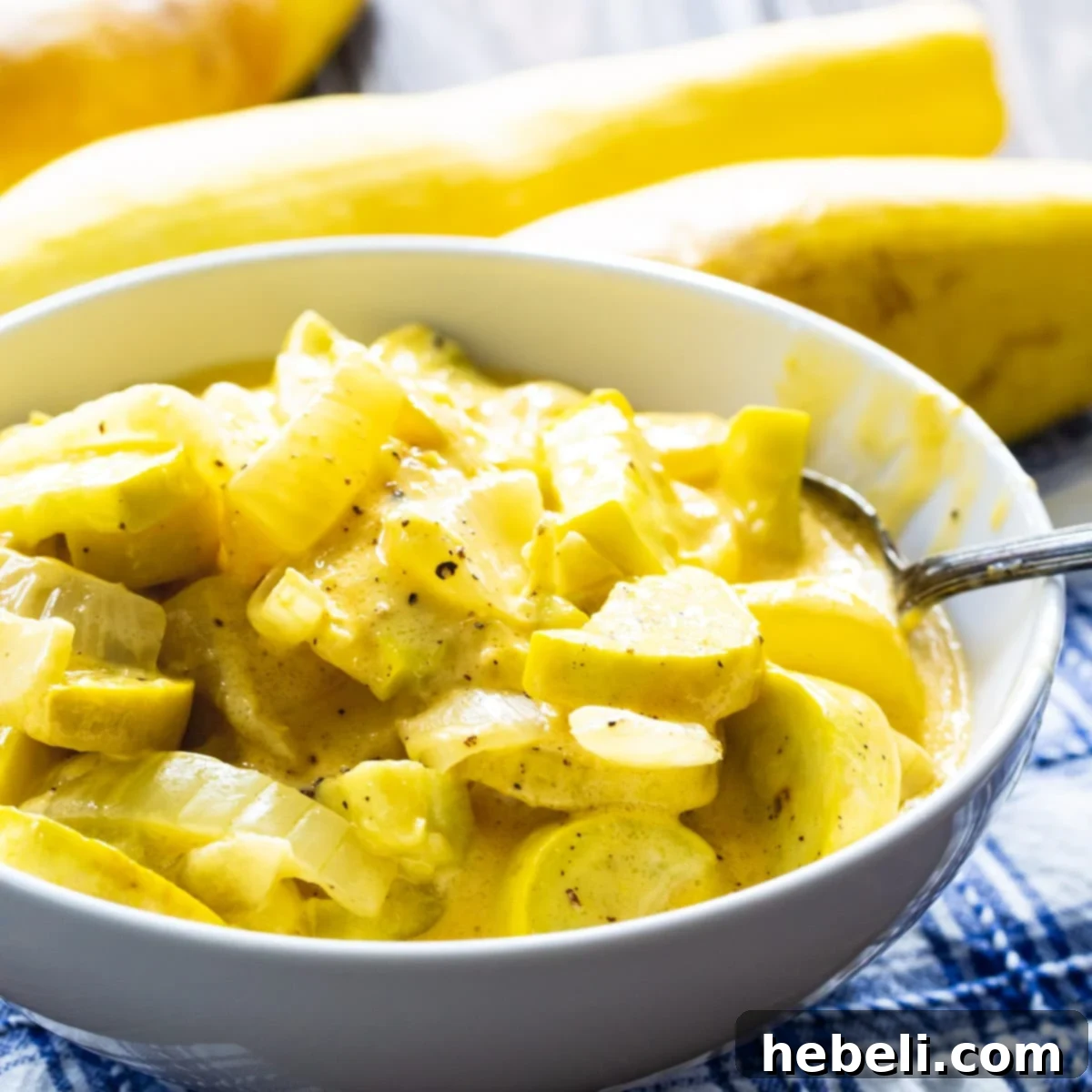 Slow Cooker Cheesy Squash in a white serving bowl, garnished and ready to enjoy.