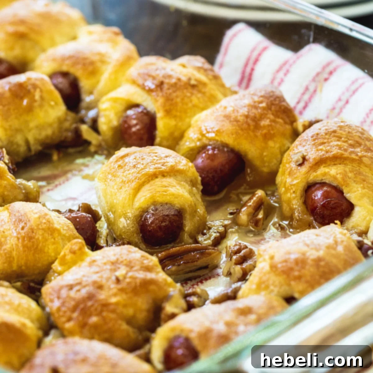 Sweet Little Smokies Rolls in a baking dish, golden brown and glistening.
