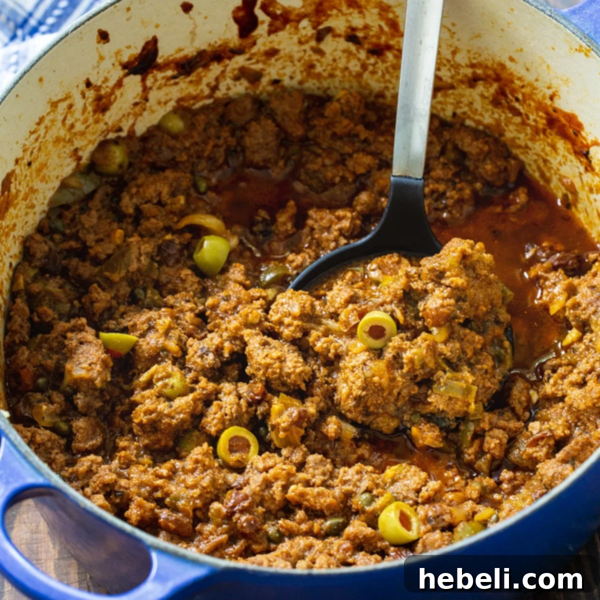 Flavorful Homemade Picadillo 2 Rich Cuban Picadillo simmering in a blue Dutch oven, ready to be served.