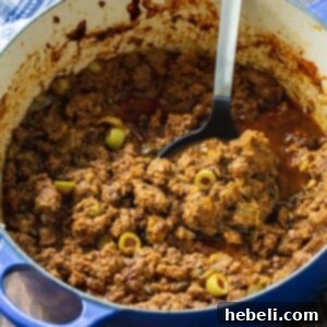 Authentic Cuban Picadillo in a Dutch oven, garnished and ready.