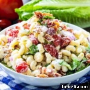 Pasta Salad with bacon, lettuce, and tomato in a white bowl, ready to be served.