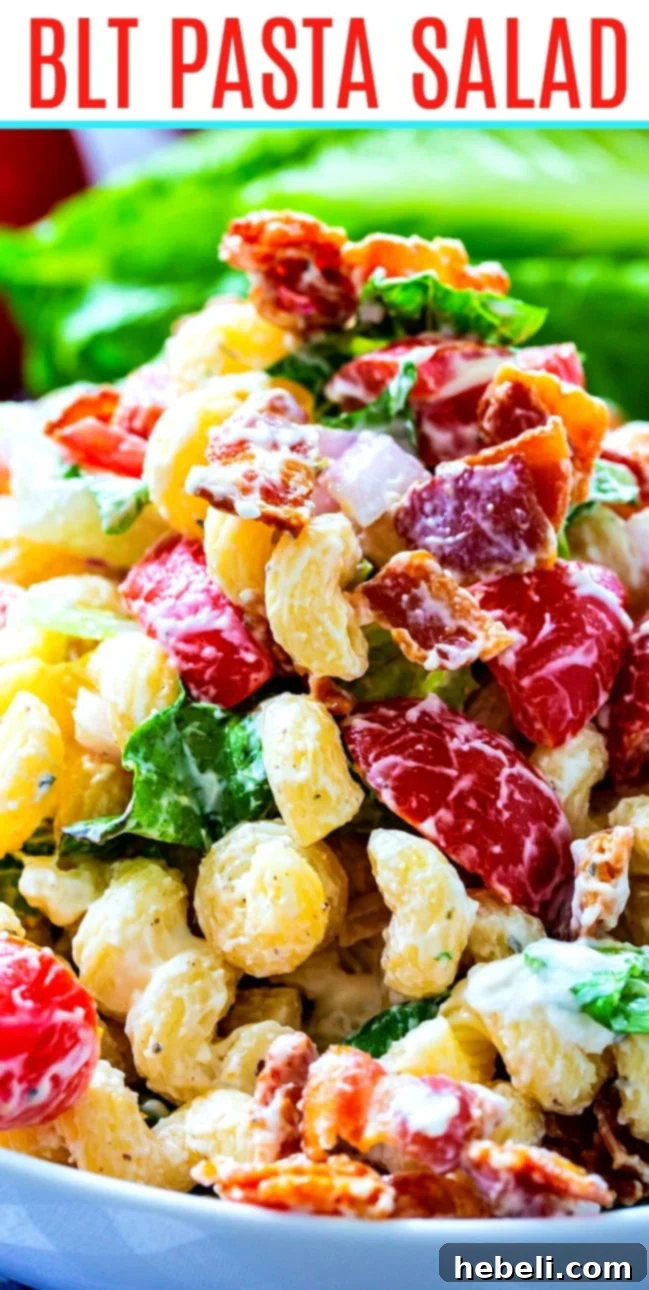 Close-up of BLT Pasta Salad, showing off the creamy dressing coating each piece of pasta, bacon, and tomato.