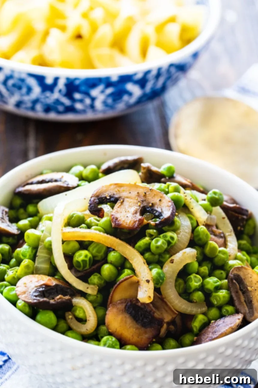 A close-up shot of Buttered Peas with Mushrooms in a pristine white bowl, ready to be enjoyed.