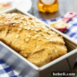 Golden Honey Oat Loaf 5 Loaf of Honey Oat Wheat Bread in a pan, still warm and golden.