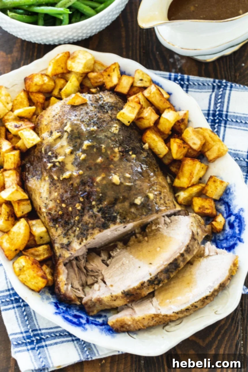Slices of juicy Garlic Butter Pork Loin on a platter, ready to be served, showing its tender texture.