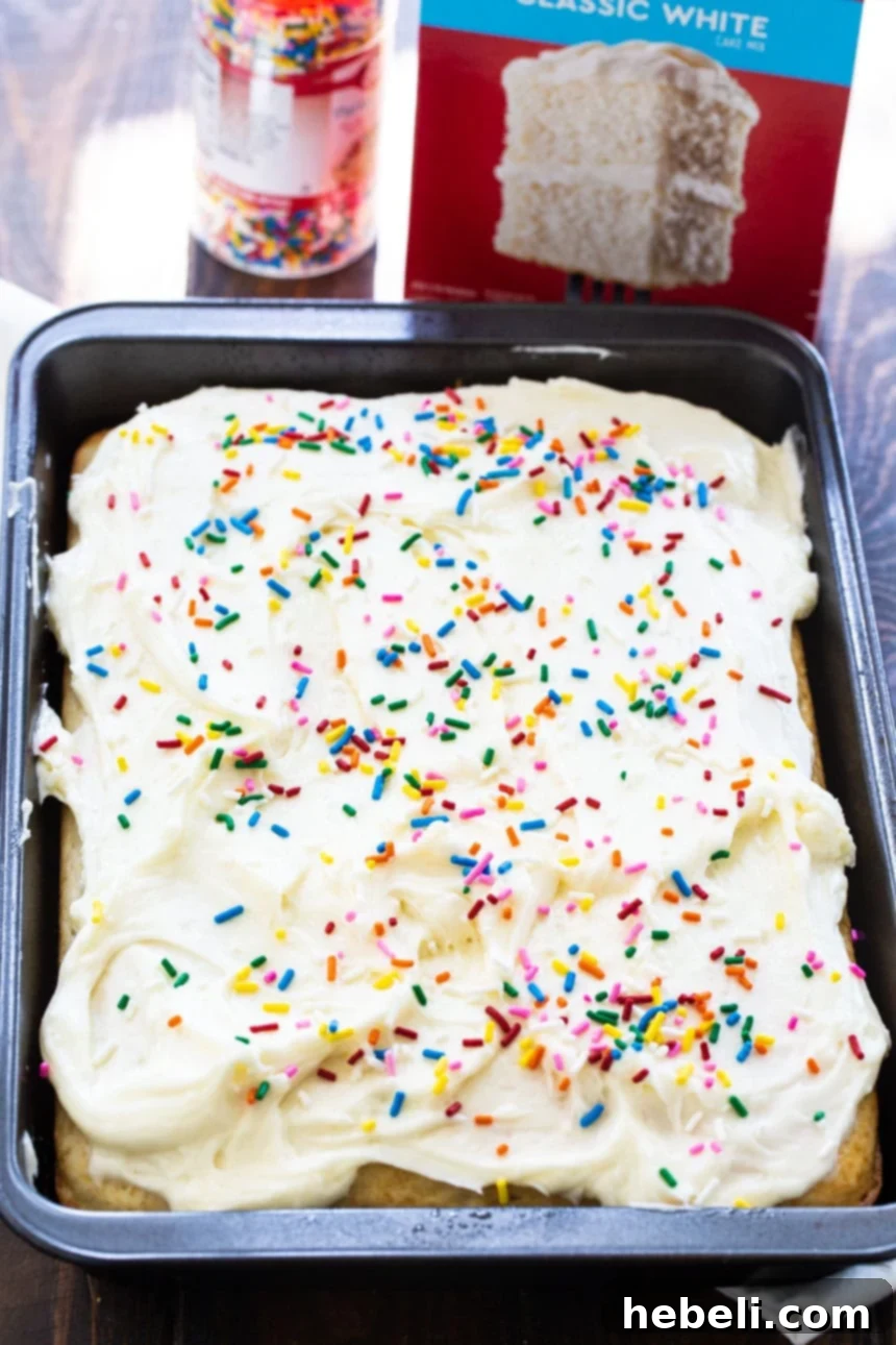White Sheet Cake with sprinkles in a 9x13-inch baking dish, ready for serving.