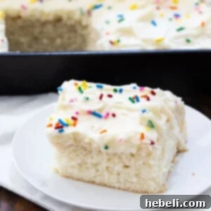 Slice of white sheet cake on a small plate.