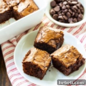 Three decadent Bittersweet Chocolate Brownies ready to be enjoyed.