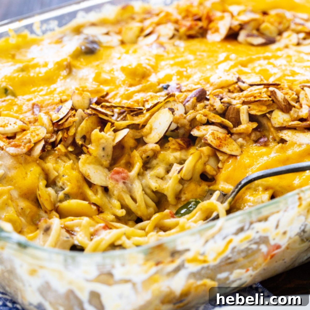 Creamy Chicken Tetrazzini 2 A large baking dish filled with Classic Chicken Tetrazzini, showcasing its creamy texture, golden cheese topping, and sliced almonds, ready to be served.