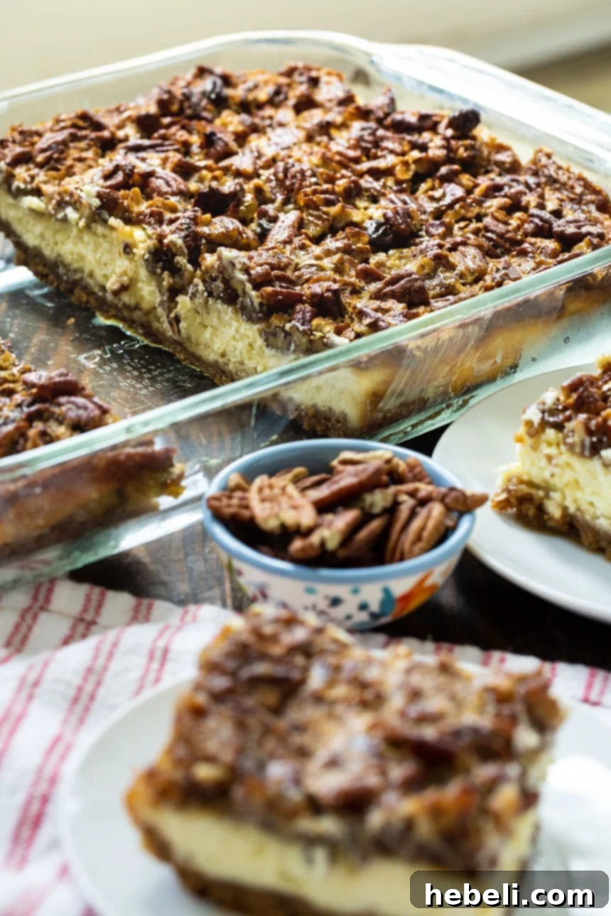 A full pan of freshly baked Pecan Pie Cheesecake Bars, ready for chilling.