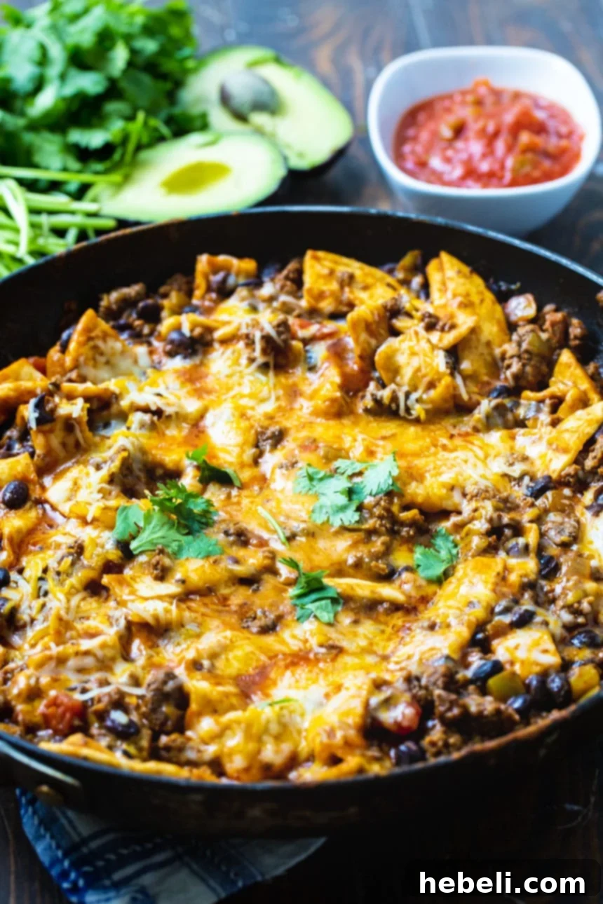 One-Pot Beef Burrito Skillet 3 Burrito Skillet in a large skillet, garnished with fresh avocado and cilantro.